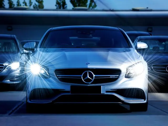 Silver Mercedes sedans in the shop lot after repair