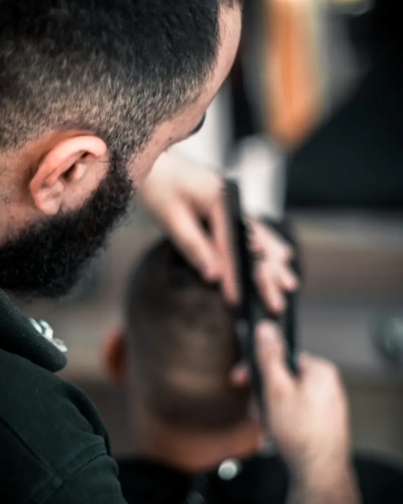 Barber cutting a fade with clippers