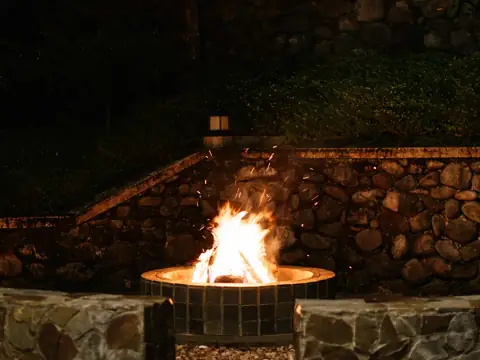 Stone fire pit glowing at night